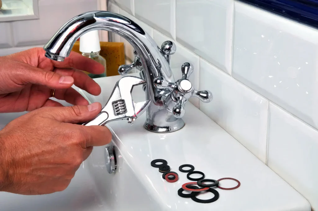Plumber performing maintenance on a bathroom faucet in Palm Coast