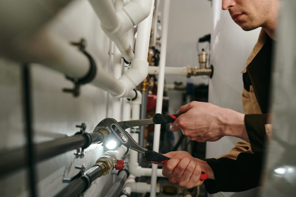 Plumbers maintaining commercial plumbing pipes in Palm Coast