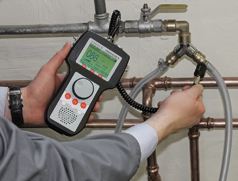 Plumber testing pipes with electronic leak detection equipment in Palm Coast