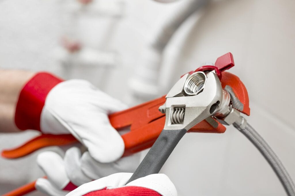 Plumber holding pipe wrenches for an emergency repair in Palm Coast