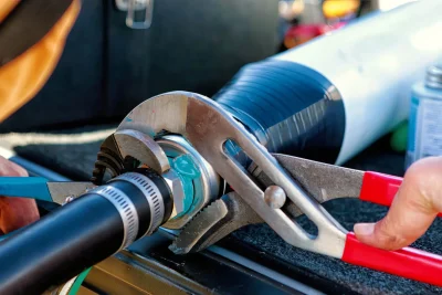 Technician tightening an industrial pipe connection in Palm Coast