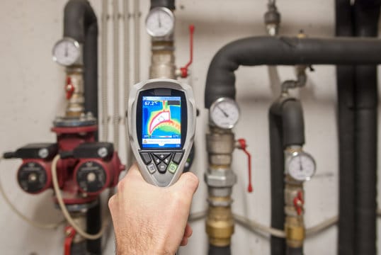 Plumber using a thermal imaging camera to inspect pipes in Palm Coast
