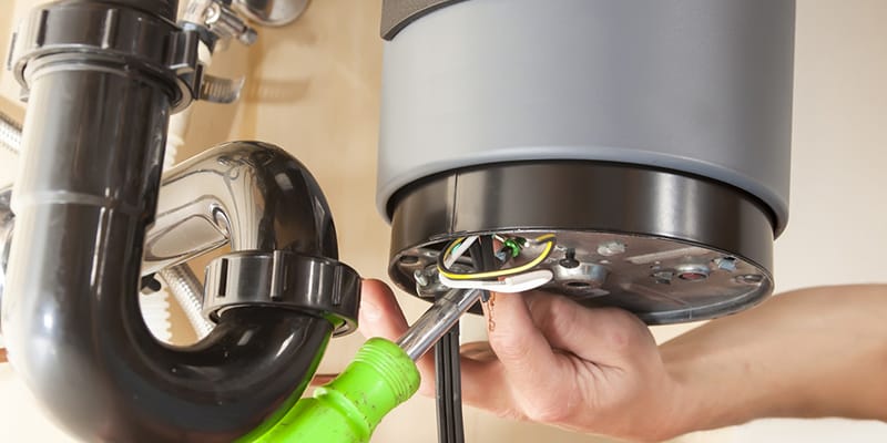 Technician repairing the heating element of a water heater in Palm Coast