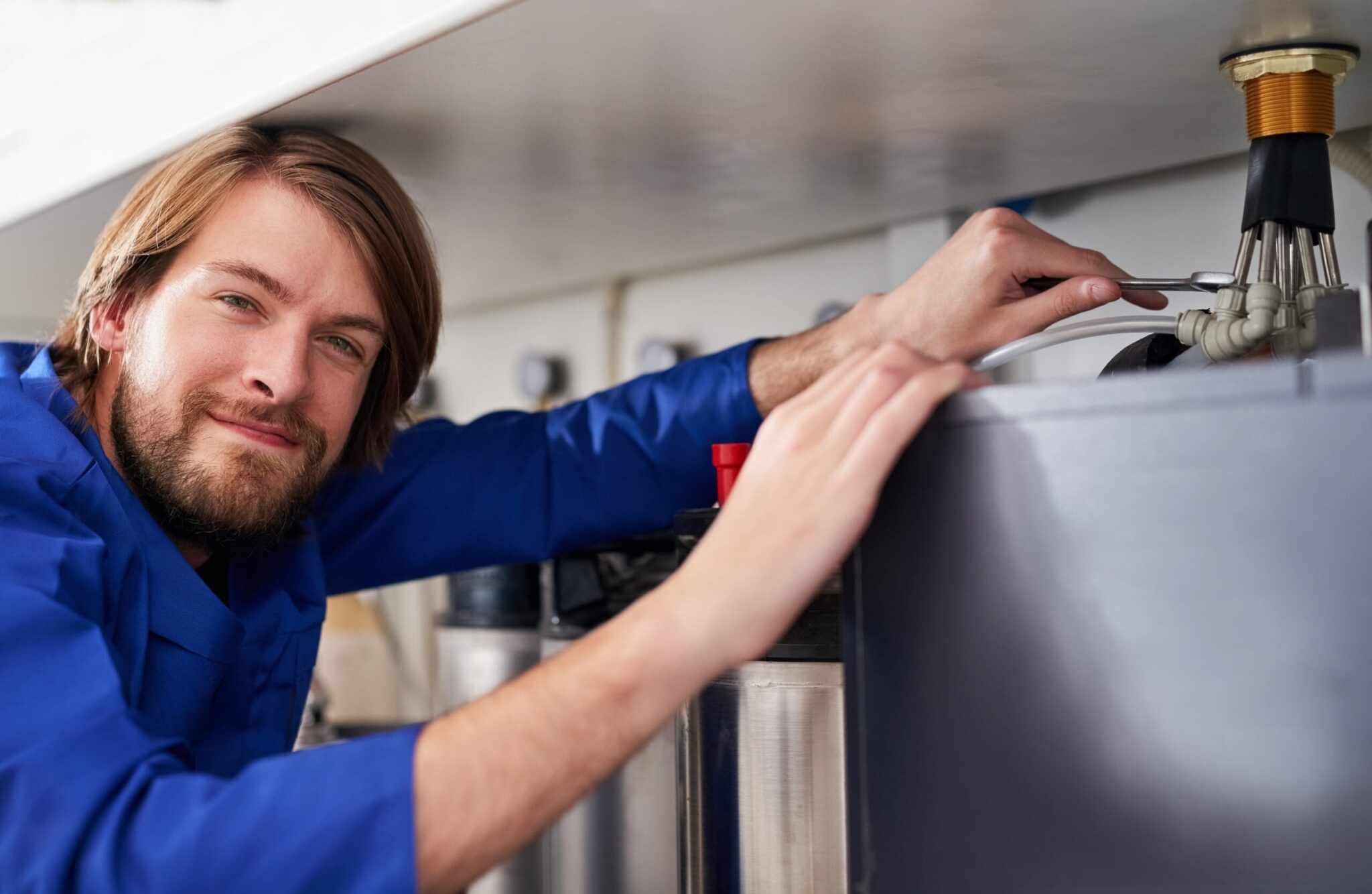 Technician servicing a residential water heater tank in Palm Coast