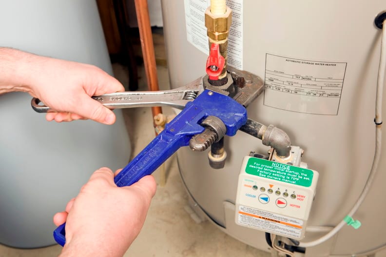 Plumber repairing a water heater valve in Palm Coast